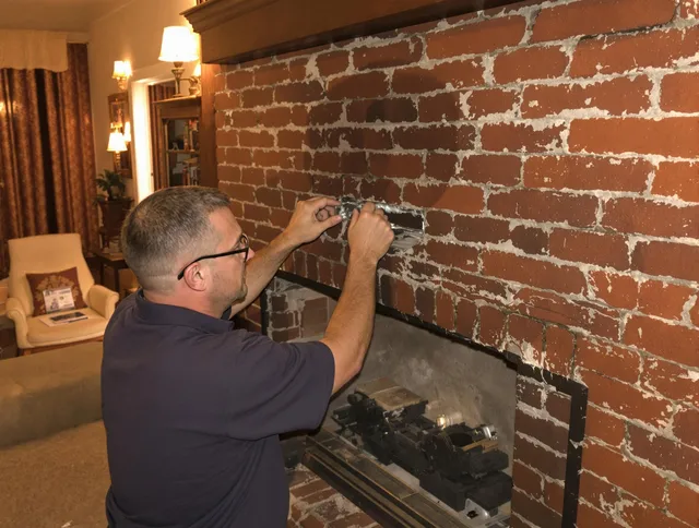 Willoughby Chimney Sweep expert fixing a fireplace in Willoughby, OH